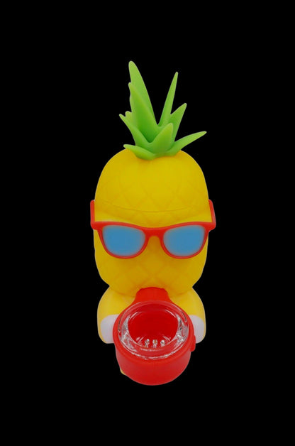 Yellow pineapple-shaped smoking device with red sunglasses and a red container for concentrates.