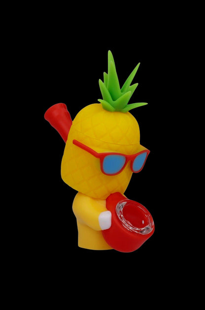 Yellow pineapple-shaped water pipe with red accents and blue sunglasses against a black background.