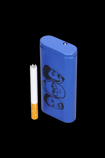 Blue metal cigarette case with illustrated faces beside a partially smoked cigarette.