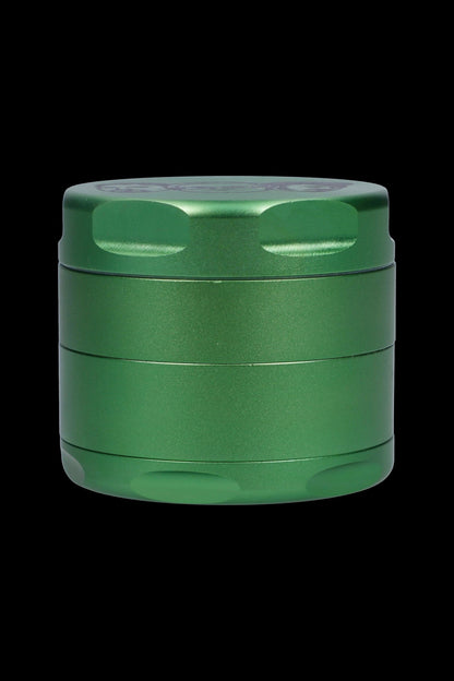 Green four-layer metal grinder for cannabis.