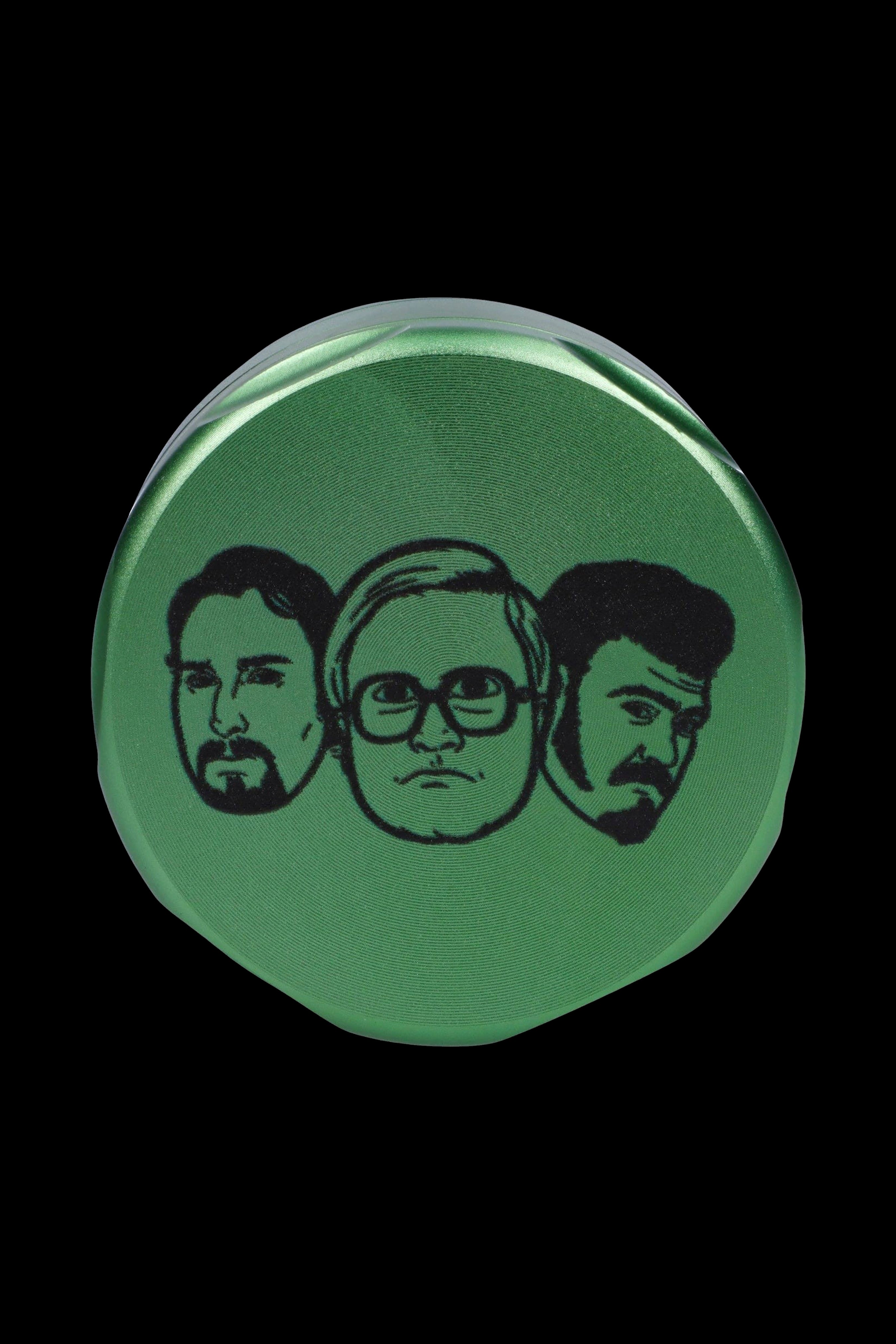 Green grinder featuring portraits of Tommy Chong, Cheech Marin, and Willie Nelson.