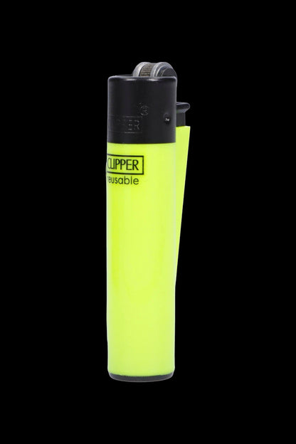 Neon yellow Clipper lighter isolated on a black background.