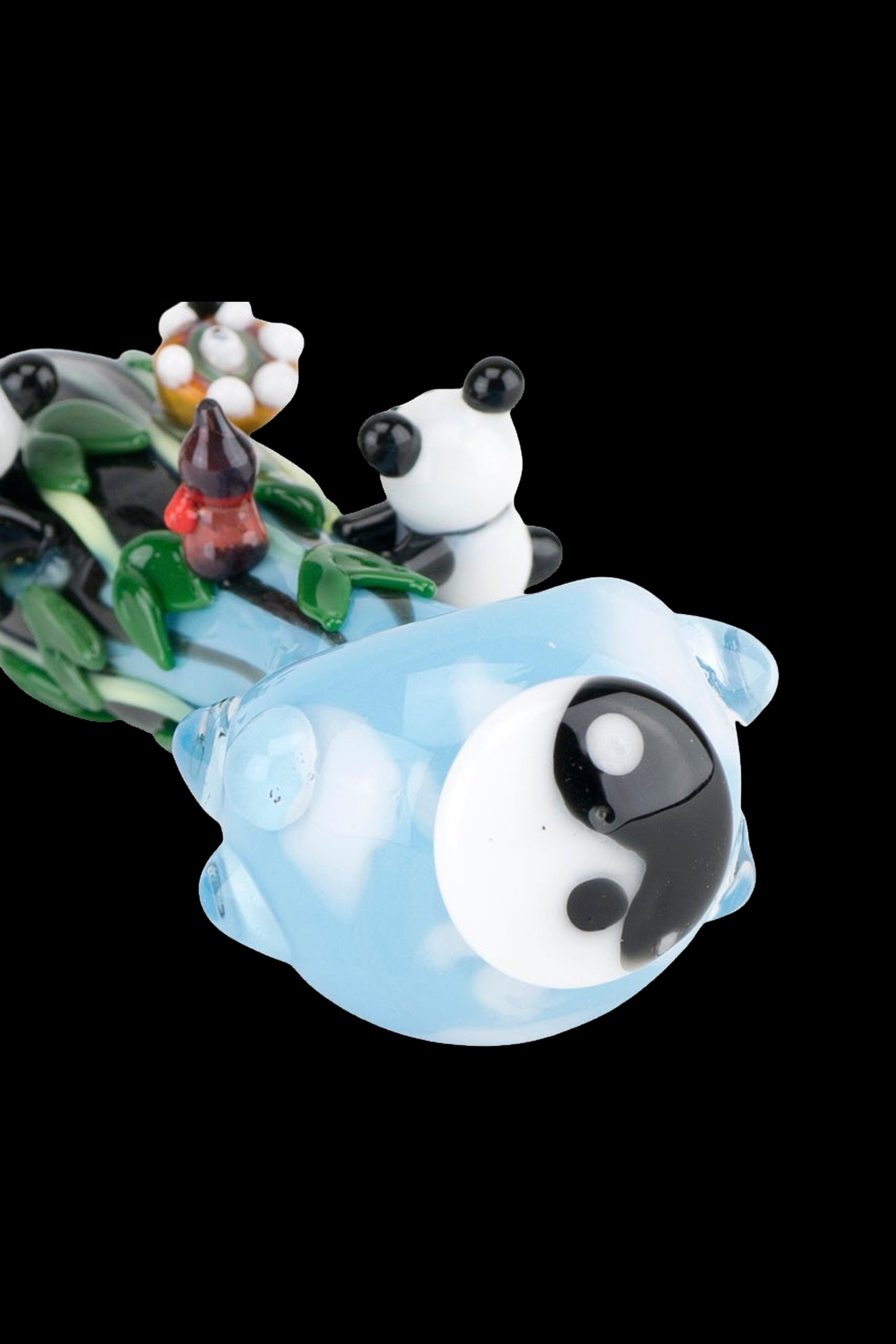 Hand-blown glass water pipe shaped like a panda relaxing in a yin-yang bubble bath, surrounded by colorful floral accents.