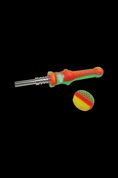 Green and red cannabis dab tool and carb cap on a black background.
