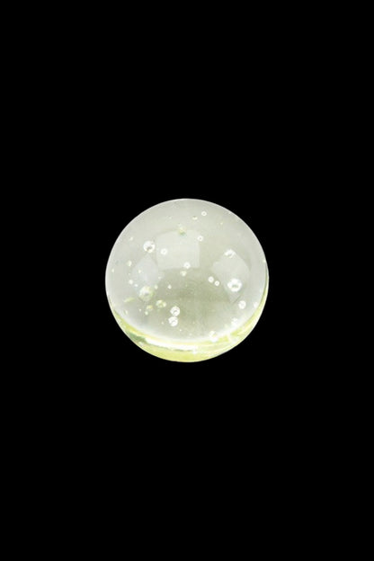 Close-up of green cannabis concentrate oil with bubbles.