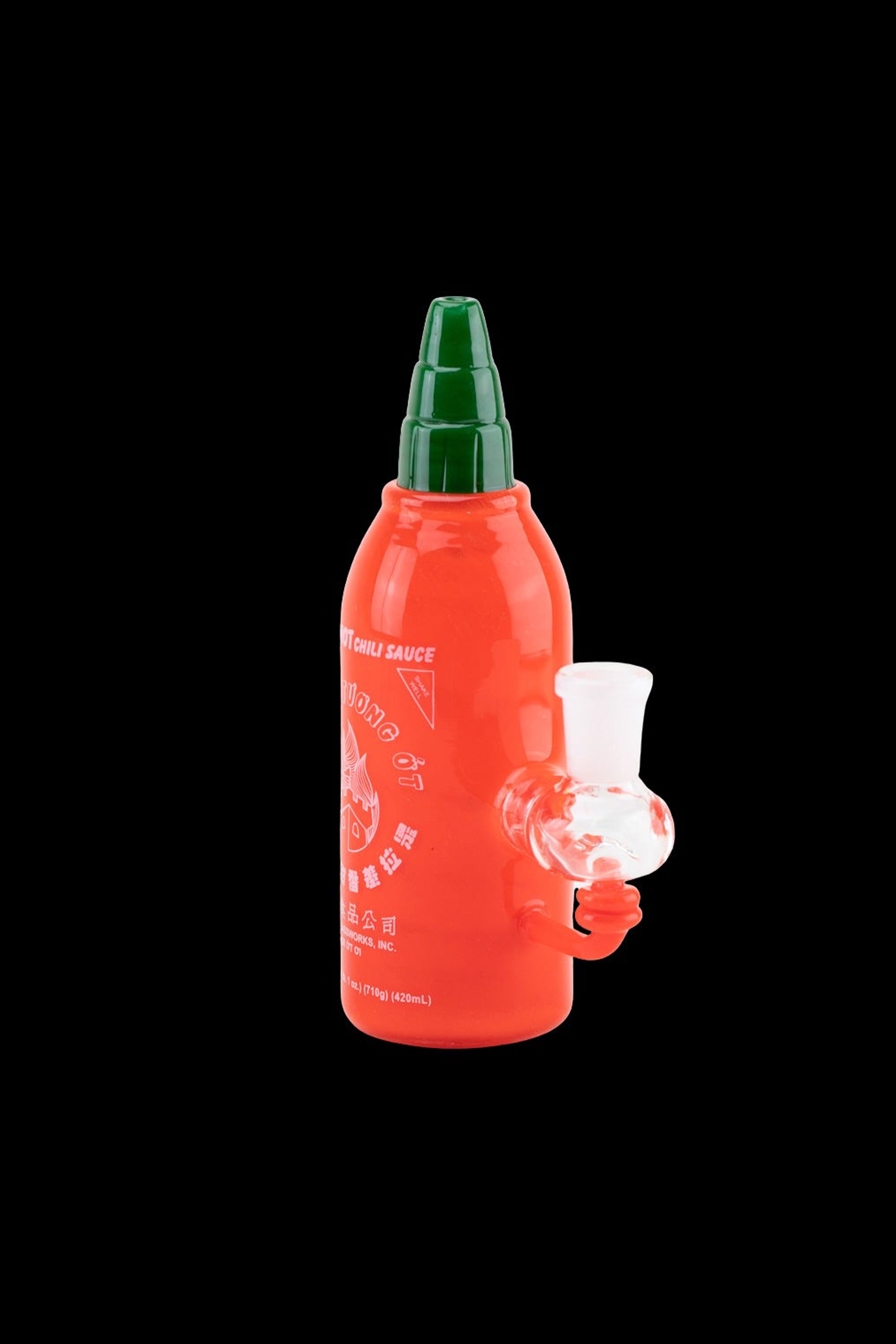 Sriracha bottle repurposed as a water pipe with a glass bowl.