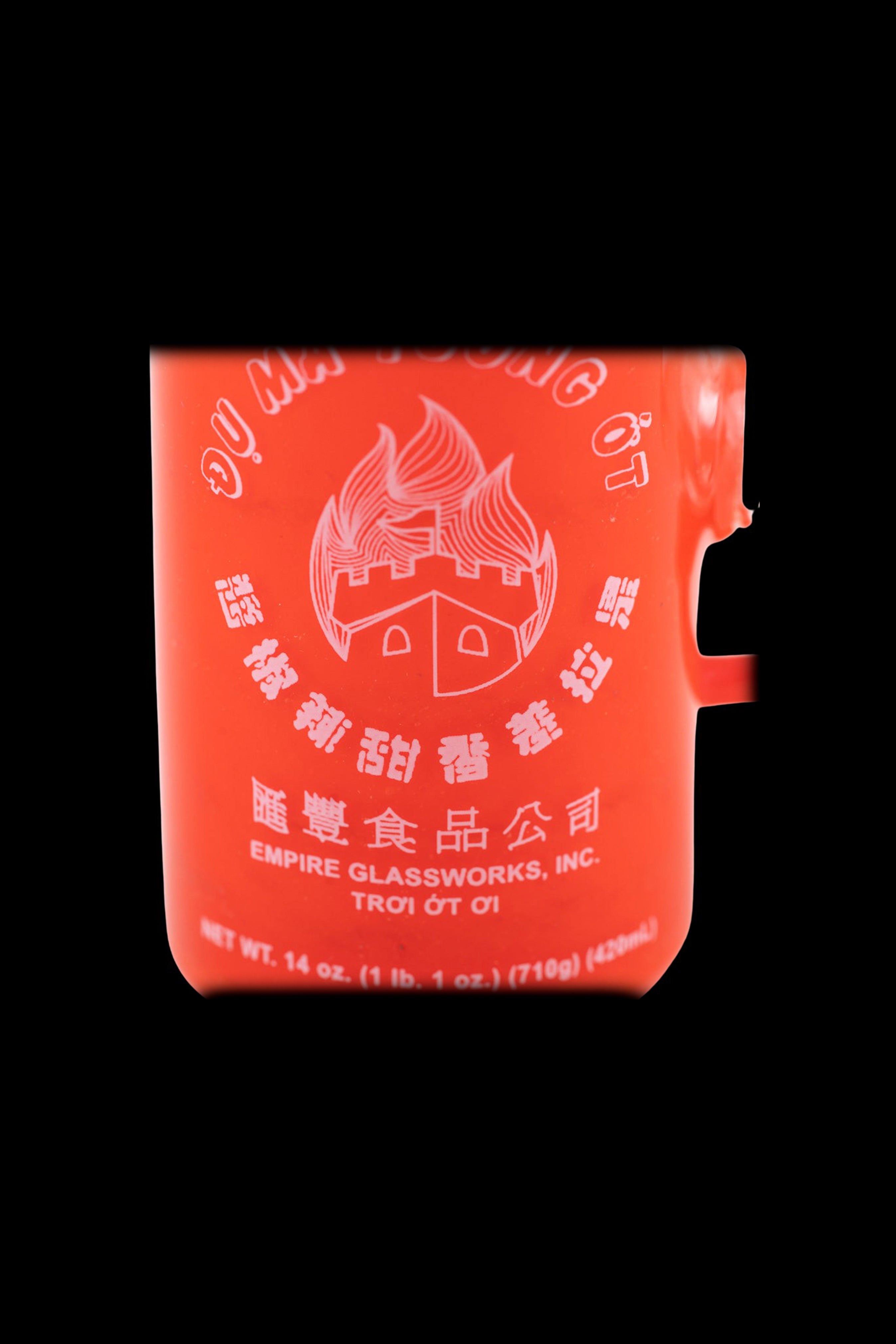 Orange cannabis storage container with Chinese-style lettering and branding for Empire Glassworks, Inc. 