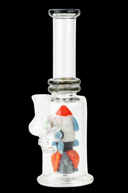 Glass bubbler water pipe with a colorful rocket ship sculpture inside.