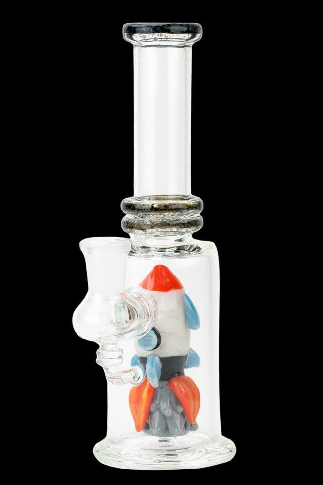 Glass bubbler water pipe with a colorful rocket ship sculpture inside.