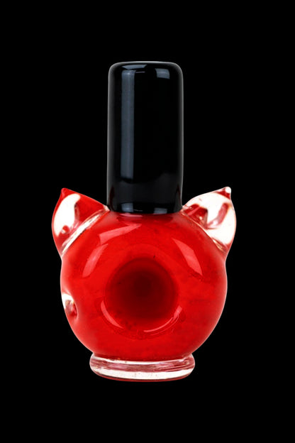Red glass pipe shaped like a cartoon devil head with horns.
