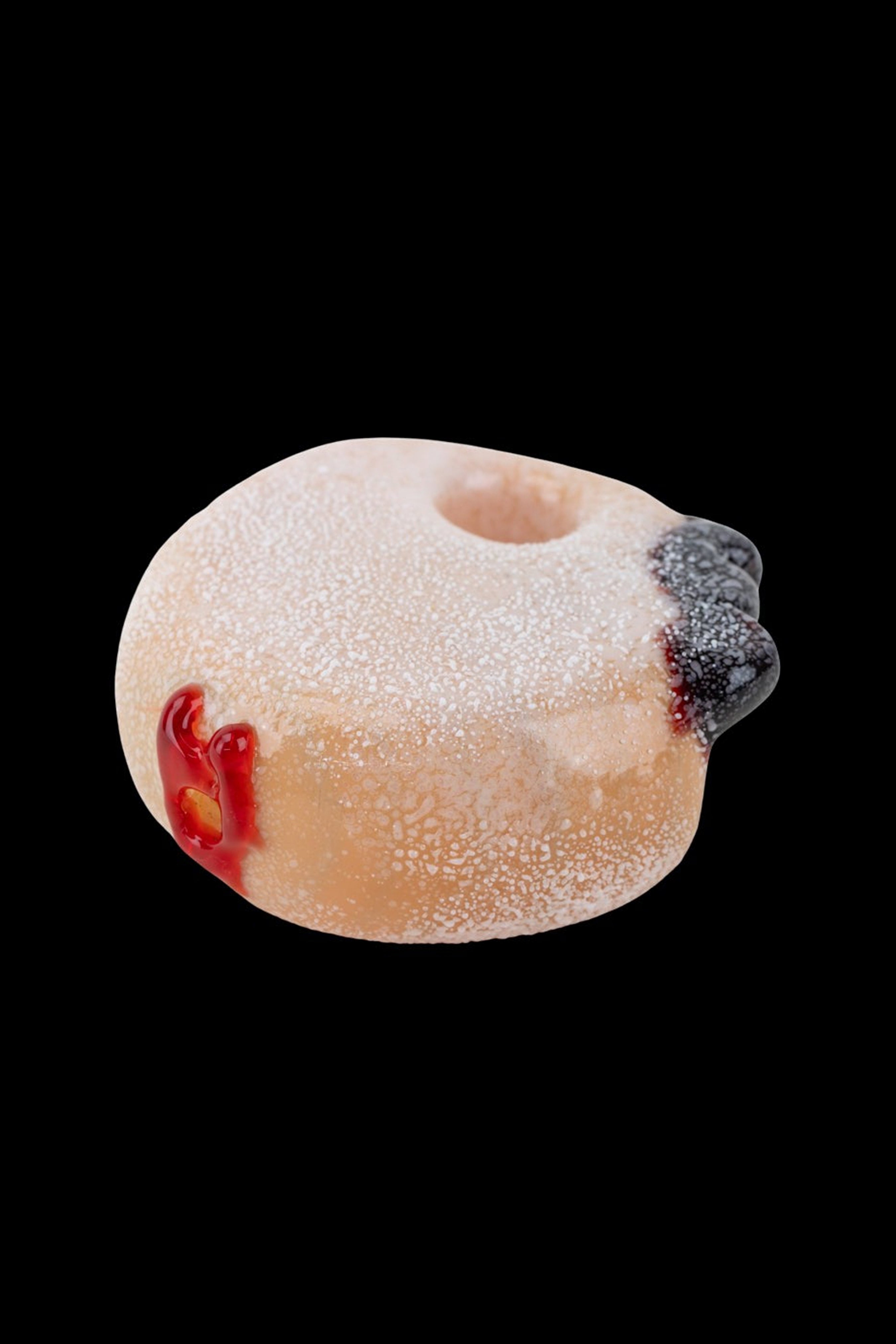 Glass pipe shaped like a powdered donut with red "glaze" and blueberry accents.