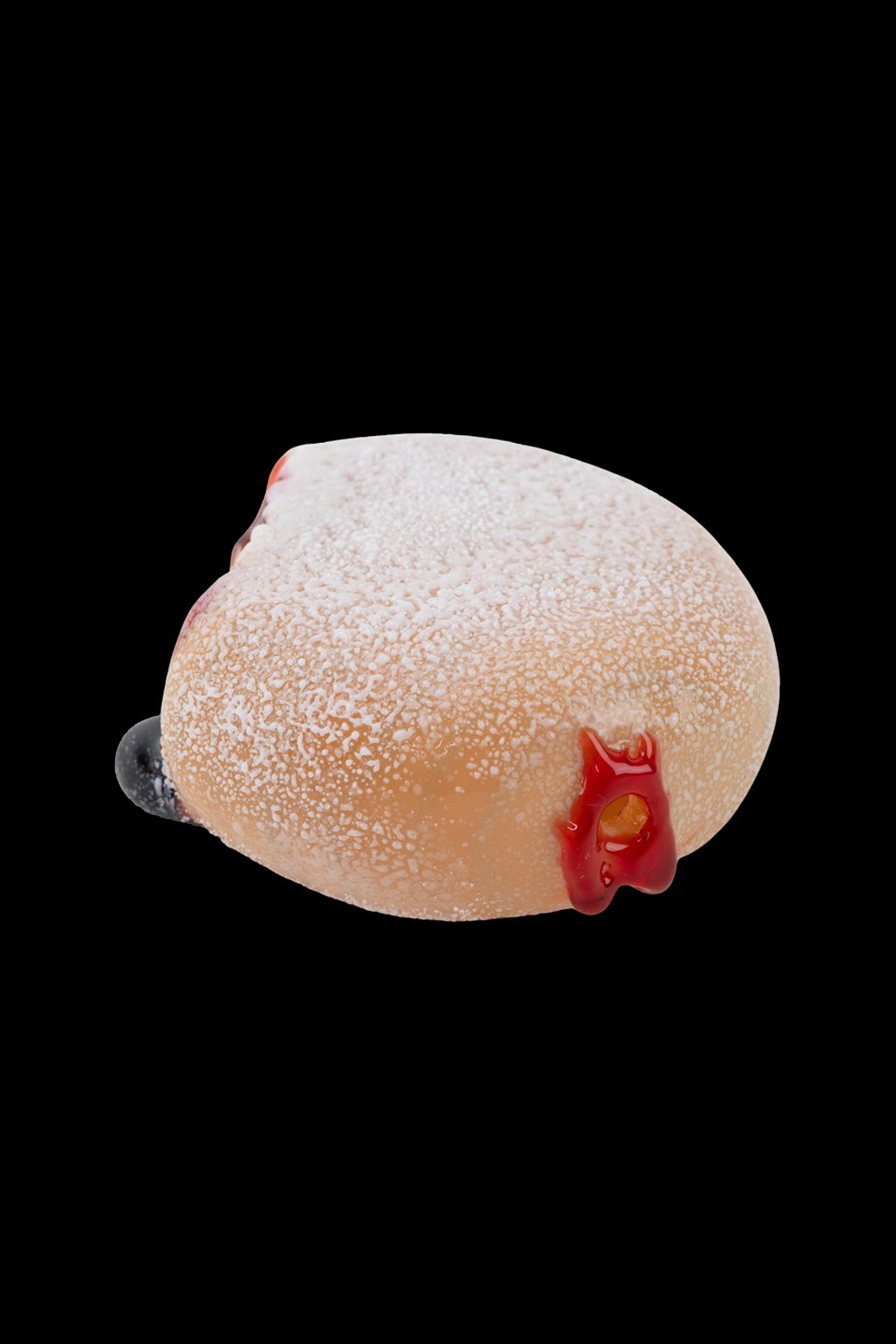 Powdered donut-shaped glass pipe with red accent and mouthpiece.