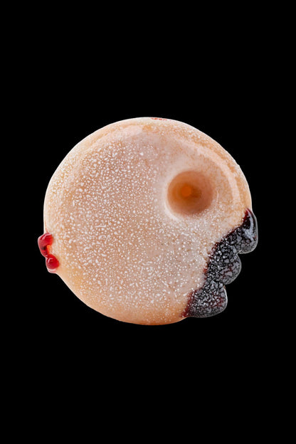 Glass pipe shaped like a powdered donut with black berry-like accents.