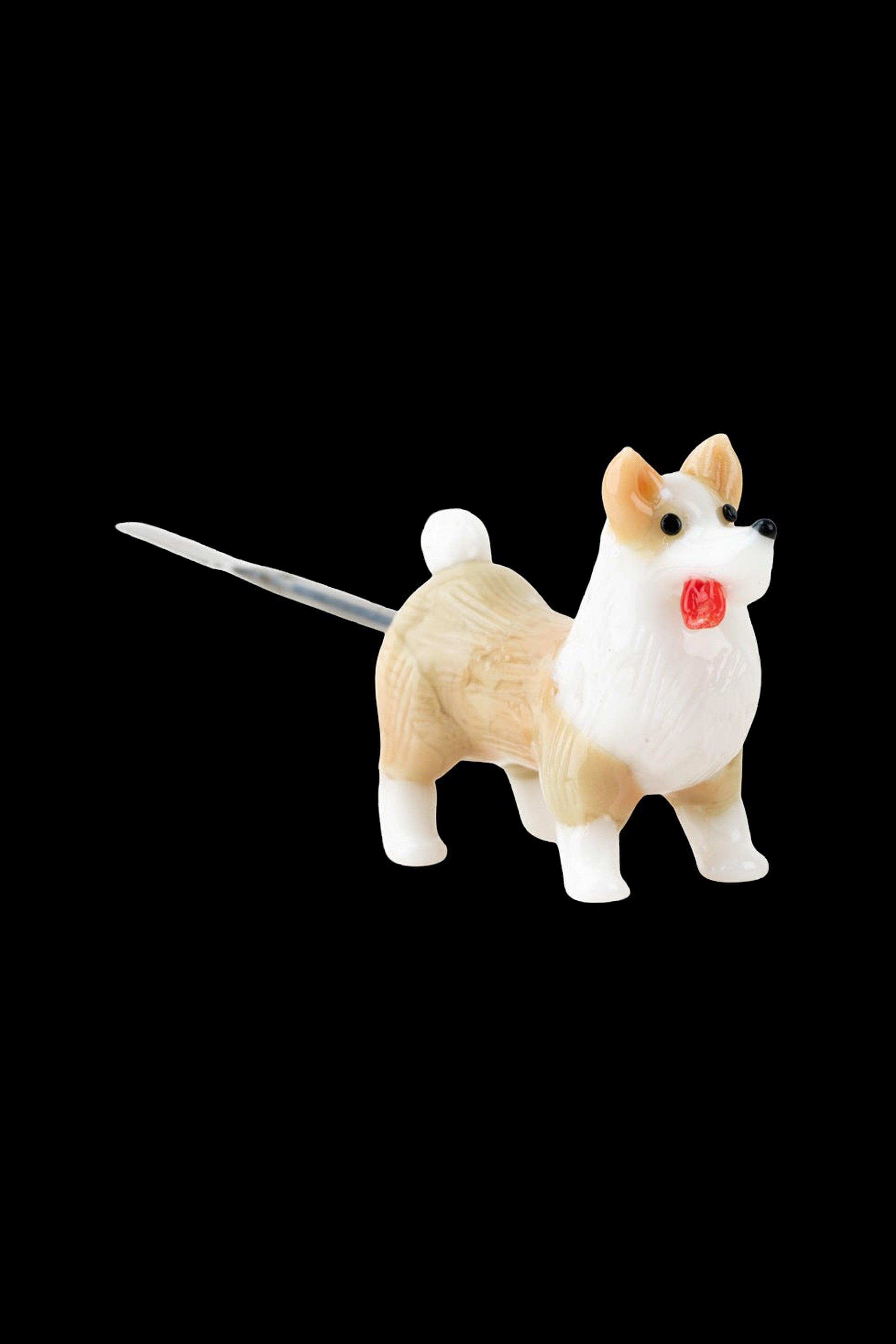 Ceramic corgi pipe with a red seal on its chest.