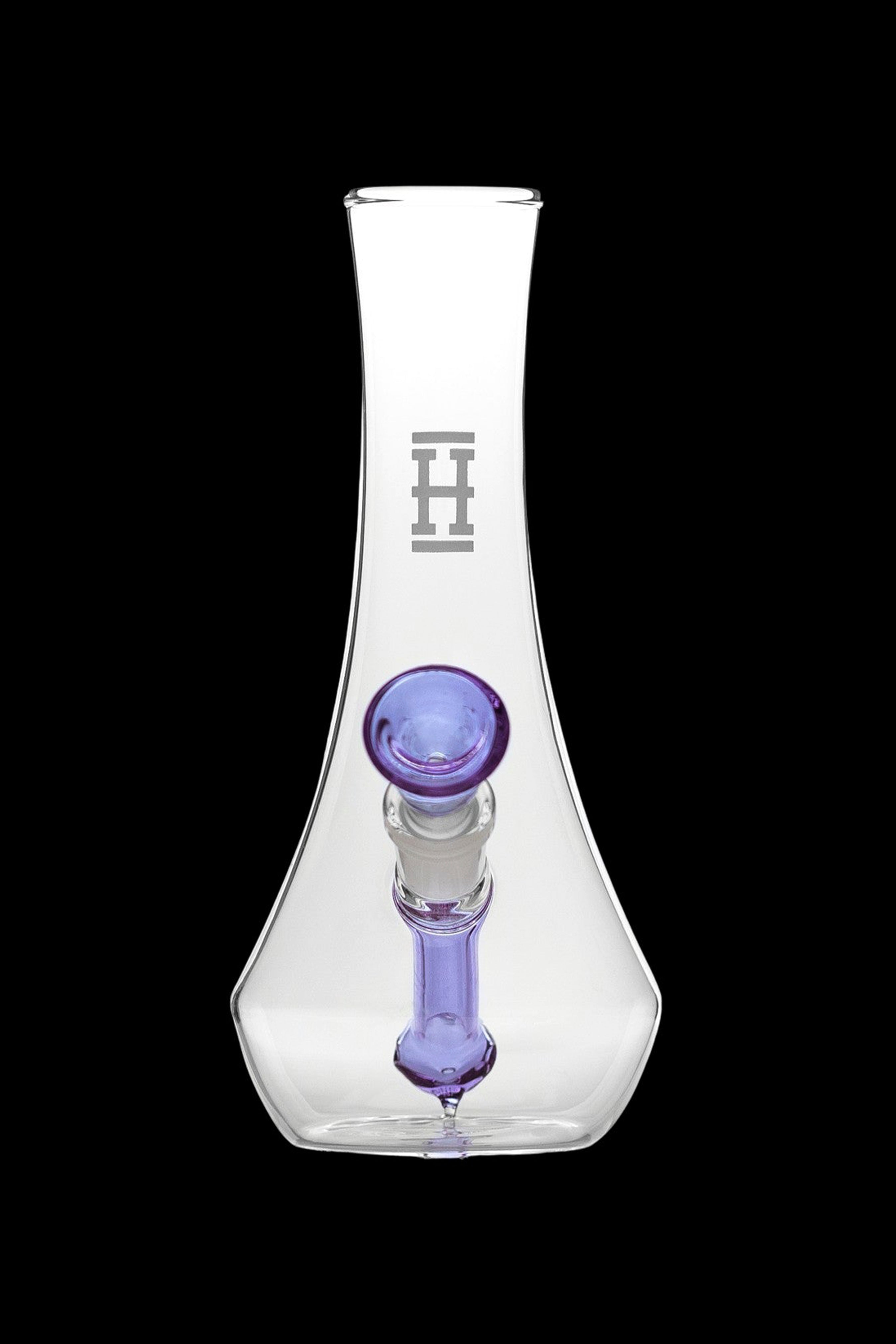 Clear glass water pipe with purple mouthpiece and etched logo.