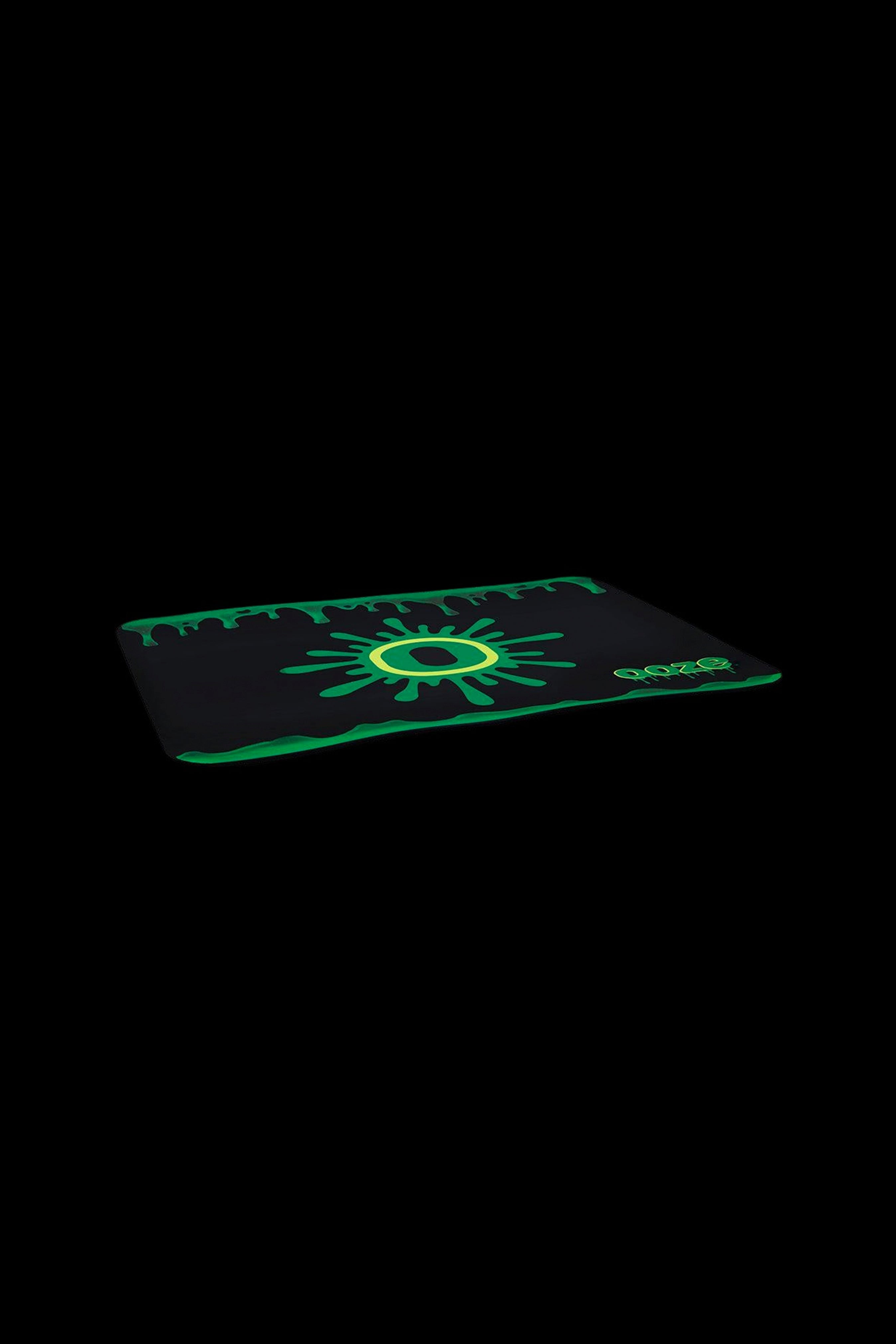 Black cannabis accessory case with dripping green accents and a central glowing green eye design.
