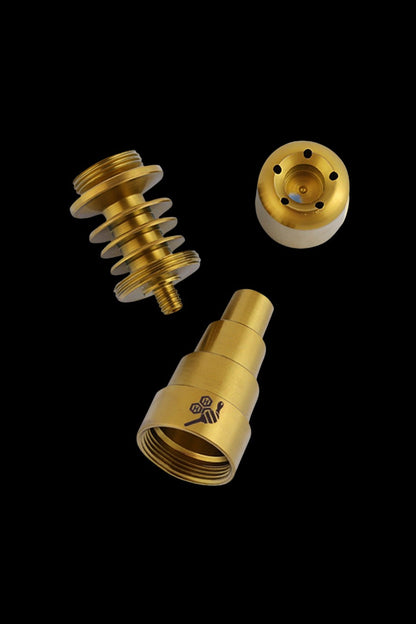 Gold cannabis oil rig parts disassembled on a black background.