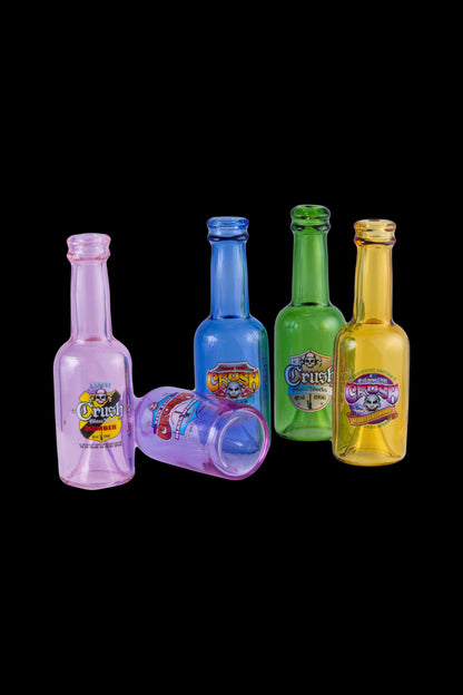 Colorful glass oil bottles and a shot glass with cannabis-themed branding against a black background.