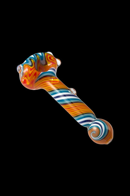 Colorful glass smoking pipe against a black background.