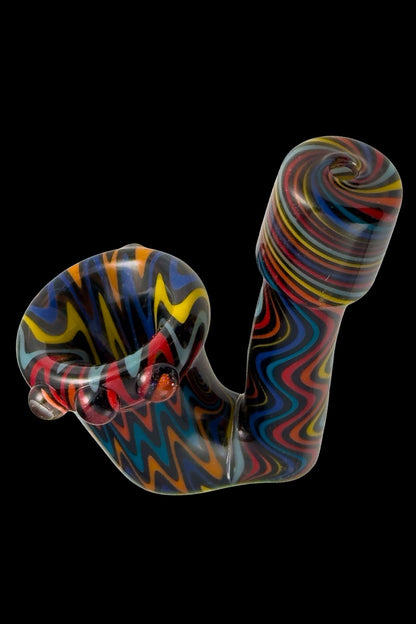 Colorful glass cannabis pipe with swirling patterns against a black background.