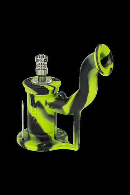 Green silicone oil rig with metal downstem and dab tool.