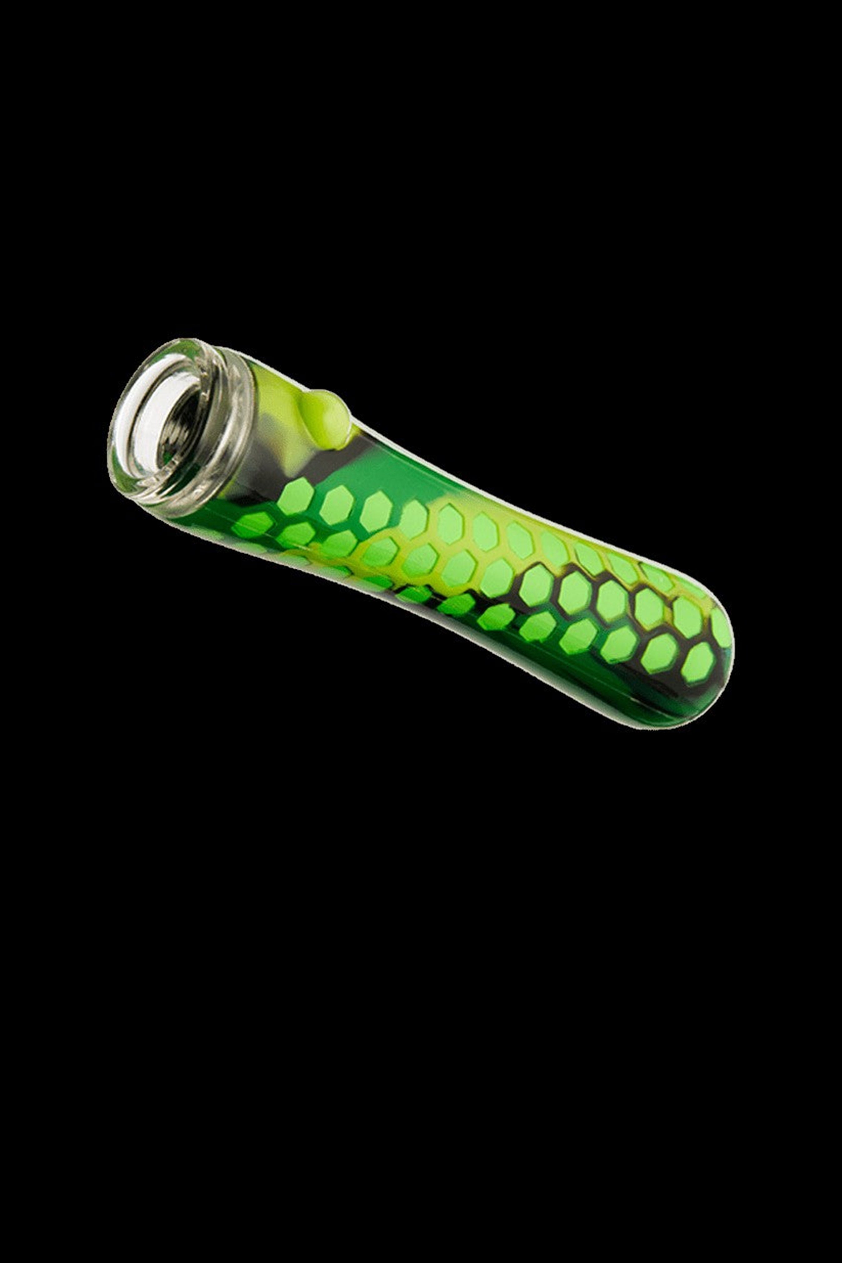 Green glass pipe with honeycomb pattern against a black background.