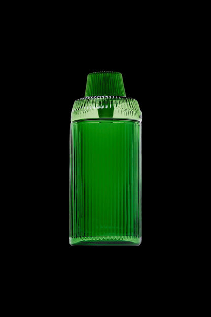 Green glass cannabis oil container on a black background.