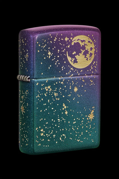 Zippo lighter with a celestial design featuring a crescent moon and golden stars on a gradient purple-to-teal background.