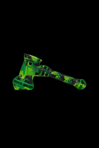 Green glass dab rig with intricate swirling patterns, isolated on a black background.