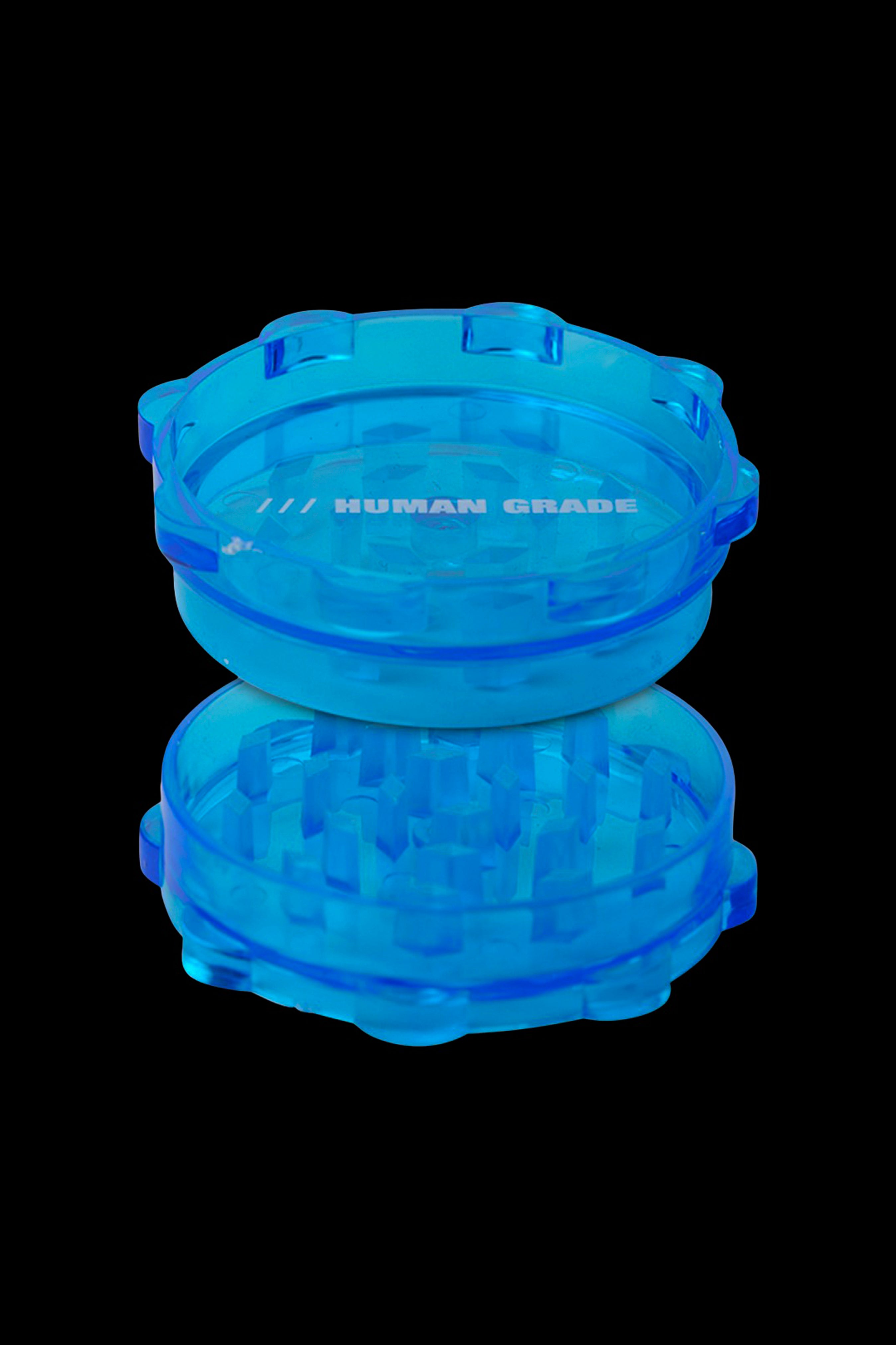 Blue cannabis grinder with “HUMAN GRADE” text.