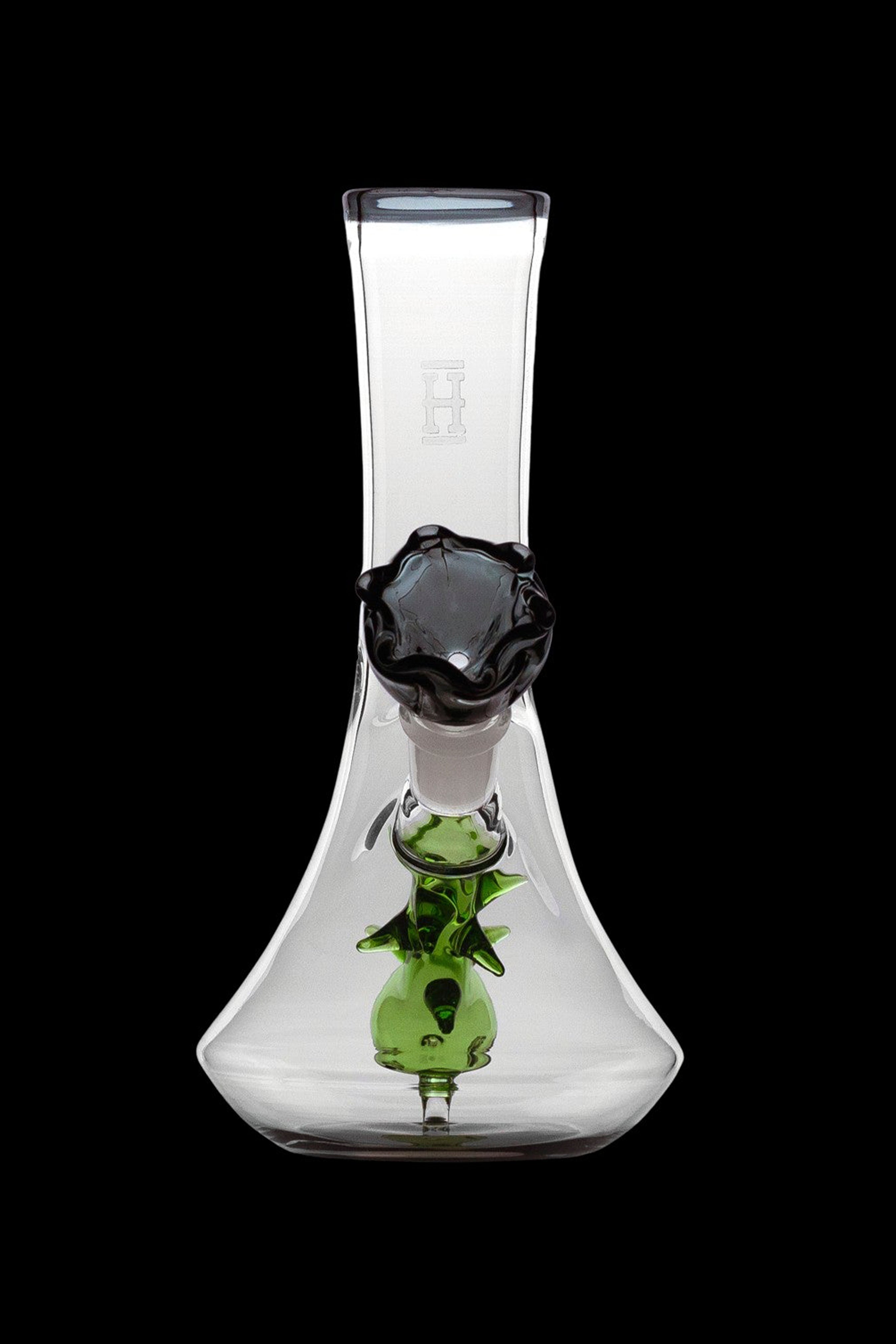 Clear glass bubbler water pipe with green sculpted accents and a black mouthpiece.