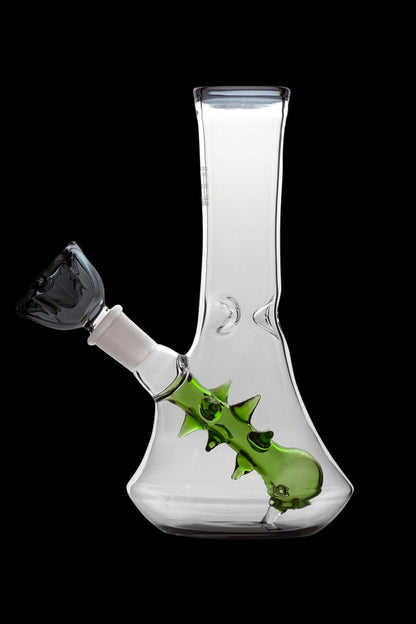 Glass bong with a green, thorn-covered downstem and black mouthpiece, isolated on a black background.