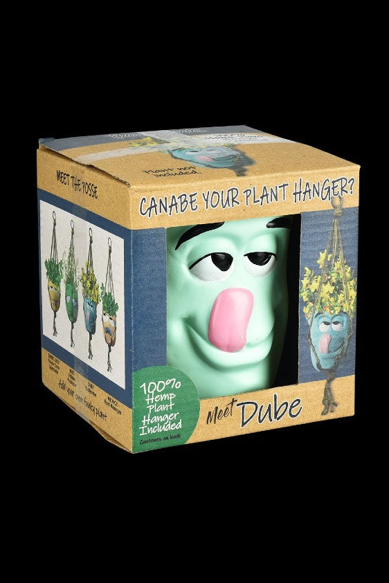 A product box featuring a cartoonish, green face named “Dube” and advertising a 100% hemp plant hanger.