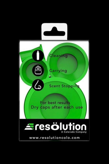 Green silicone caps for cannabis containers, packaged with icons indicating uses for cleaning, carrying, and odor control, from Resolution Colorado.