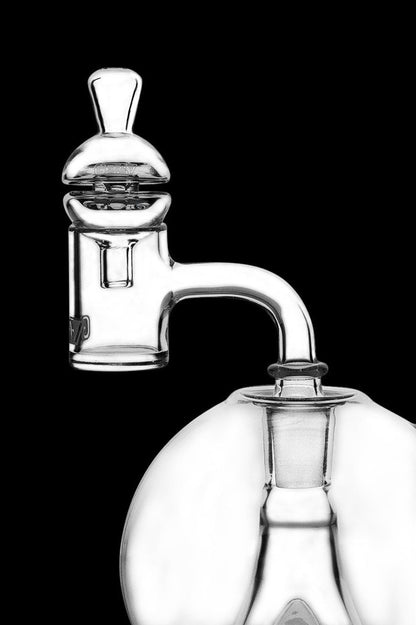 Clear glass dab rig with rounded base and intricate mouthpiece.