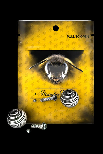 Packaging for “Honeybee” cannabis accessories featuring a close-up of a bee's face and coiled metal tools.