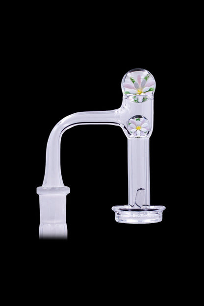 Clear glass cannabis oil rig with floral detailing.
