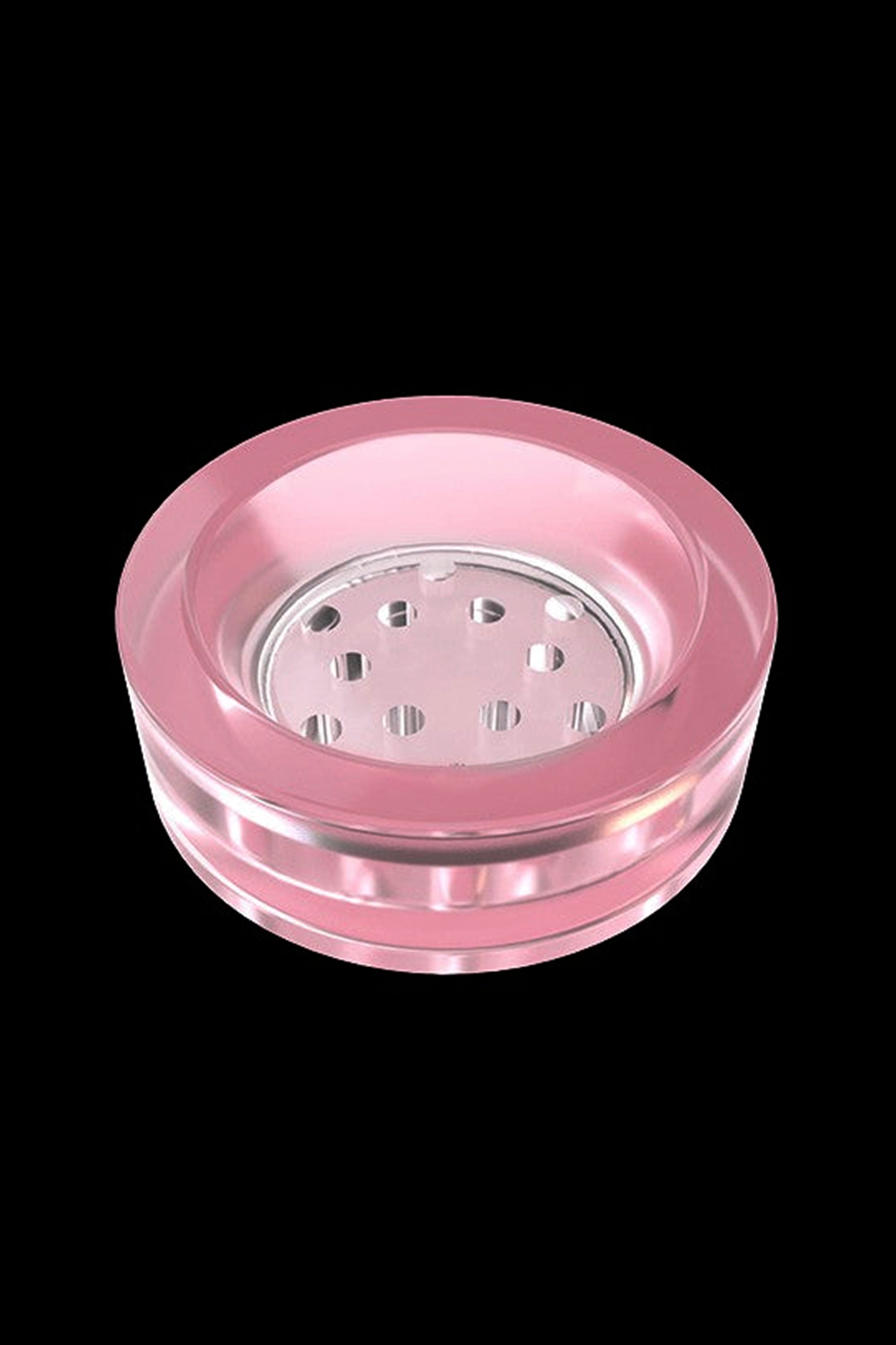 Pink glass ashtray with multiple bowl-shaped indentations for holding cigarettes or cannabis joints.