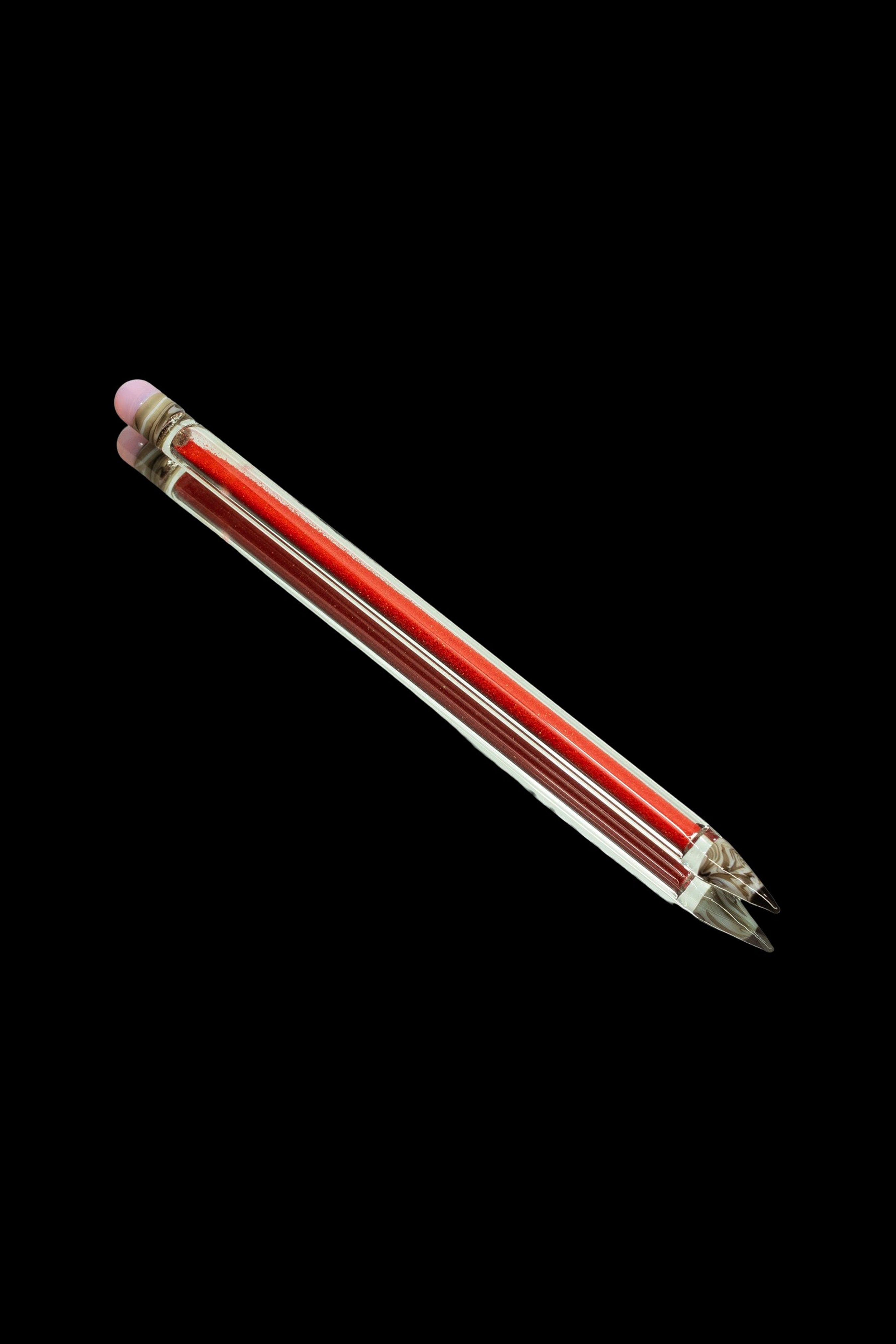 Red glass cannabis oil burner pipe on black background.