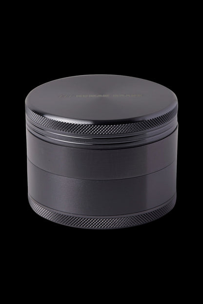 Black four-piece cannabis grinder.