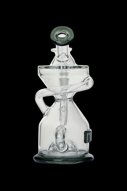 Clear glass dab rig with intricate curves and a bubbler design, isolated on a black background.