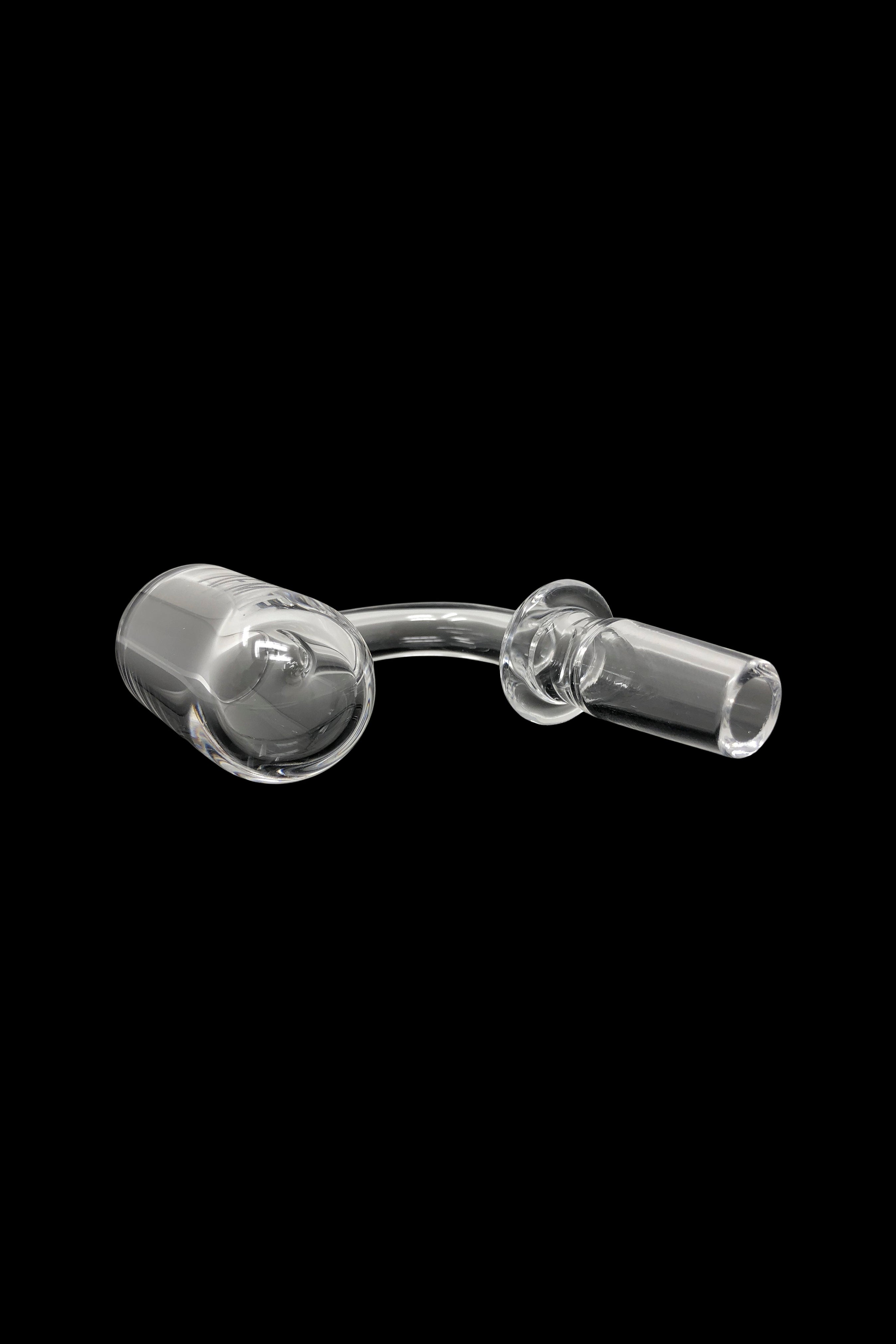 Clear glass dab rig nail and carb cap isolated on a black background.