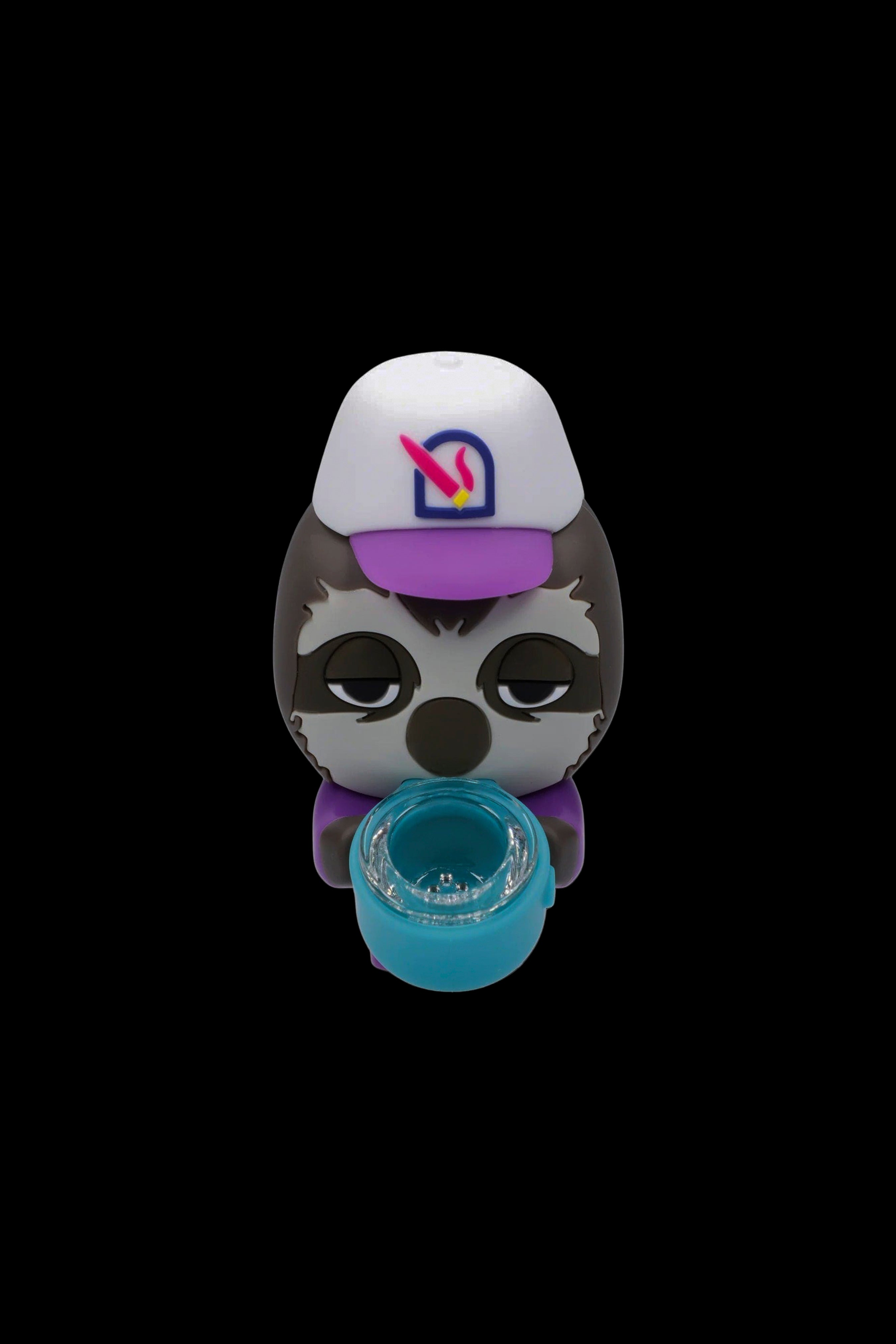 Cartoon skull-shaped silicone container with a removable turquoise cup, wearing a white cap with a purple and pink logo.