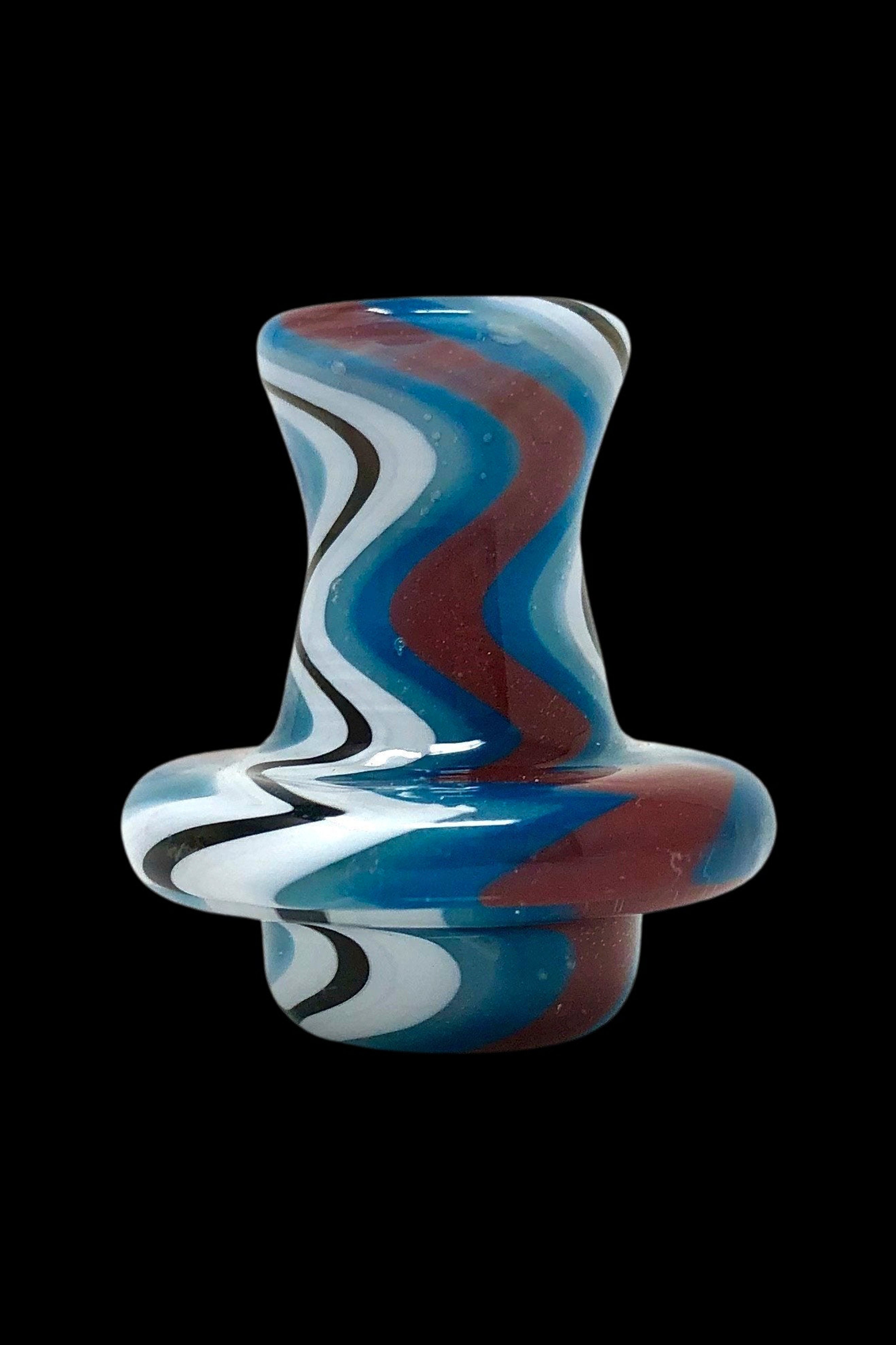Hand-blown glass cannabis oil rig with red, white, and blue swirling patterns.