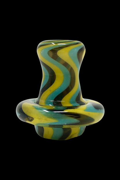 Green and yellow glass cannabis oil rig carb cap.