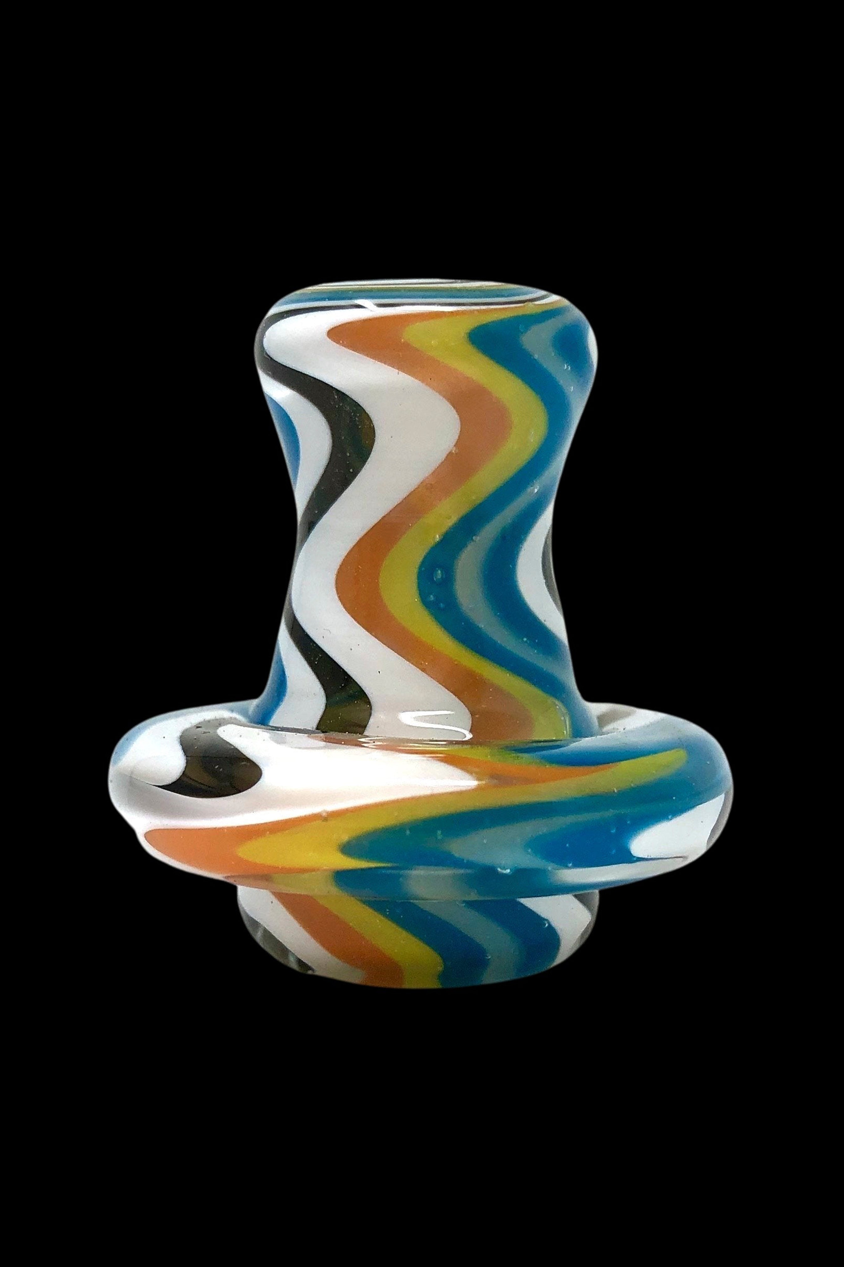 Hand-blown glass cannabis oil rig with colorful swirling patterns.