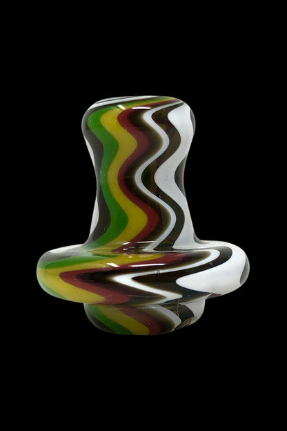 Handblown glass bubbler with swirling green, white, and brown patterns.