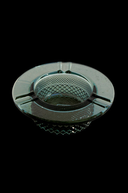Vintage green glass ashtray with a diamond pattern.
