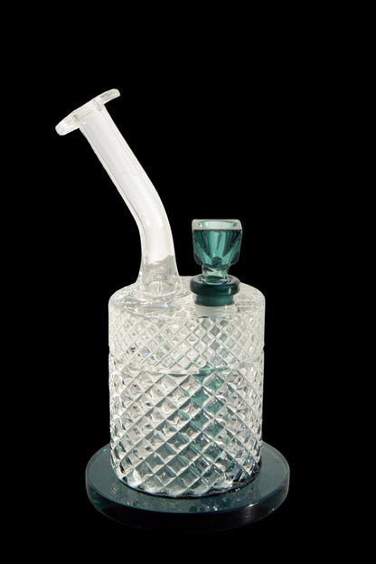 Clear glass water pipe with a diamond-patterned body and teal accents, isolated on a black background.