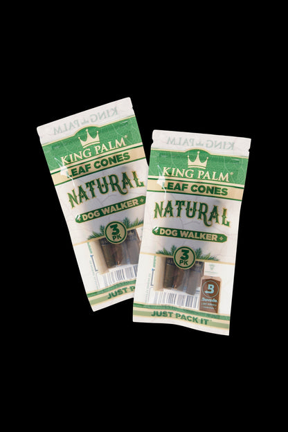 Two packages of King Palm Natural pre-rolled cones, labeled "Dog Walker" and containing three cones each, against a black background.